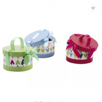 Handmade round paper gift box with ribbon lift